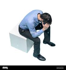 Stressed man sitting with head in hands and feeling depressed, white  background Stock Photo - Alamy