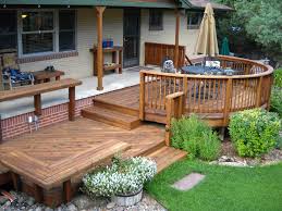 View of entrance deck with red door and front yard with outdoor rest area. Front Entry Decks Decktec Outdoor Designs