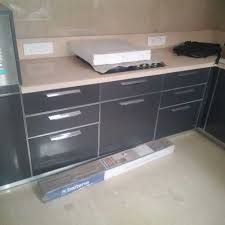 Shiny gray and wood kitchen shiny gray cabinets are combined here with large work surfaces solid wood. Modern Grey Wooden Modular Kitchen Cabinet Rs 1150 Square Feet Balaji Kitchen Interiors Id 20092648433