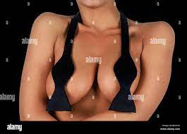 young woman wearing only a bow tie over her naked breasts curvaceous Stock  Photo - Alamy