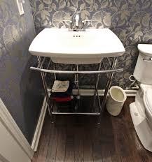 transitional powder room with metal