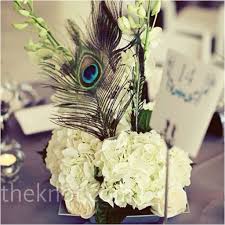 White Floral Centerpiece With Peacock Feather Flower Centerpieces Wedding Feather Centerpieces Purple Wedding Theme