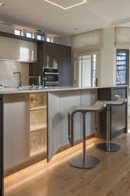 Soft Strip Shines Along The Bottom Of These Kitchen Cabinets For A Serene Effect Unique Led Ligh Minimalist Lighting Led Lighting Solutions Recessed Lighting