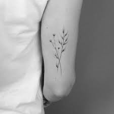 15 Dainty And Subtle Flower Twig Tattoos By Lara Maju Tattoos Back Of Arm Tattoo Tattoo Back Of Arm