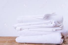 Many 100% cotton bed sheets can feel cheap, scratchy and uncomfortable, because of a very low thread count. Stack Of White Linens On Table Indoor Household Concept Fresh Stock Photo Picture And Royalty Free Image Image 116938448