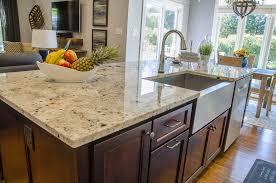 Kitchen Island With A Stainless Steel Farmhouse Sink And Stainless Steel Dishwasher Th Cherry Cabinets Kitchen Replacing Kitchen Countertops Kitchen Redesign