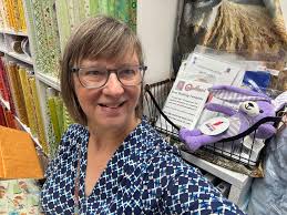 Great front window display. Lots of nautical prints. Love the jars of  buttons too! #anesh2023 #rhodeislandquiltshop #scottsentme2023  #colchestermillfabricsandquilting #colchestermillfabrics