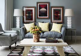 A candle chandelier illuminates this living room offering cozy seats and a brick fireplace framed with rustic mantel. Grey And Yellow Lounge Ideas Interior Design
