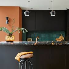 The kitchen inside this burley on the hill, england, residence decorated by mark gillette interior design is outfitted with an aga range; Black Kitchen Ideas Dark Designs For Cabinets Worktops And Feature Walls That Set A Stylish Tone