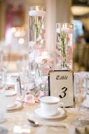 Floating Candle Centerpieces With Blush Orchids And Rose Gold Table Linens Carl Al Candle Wedding Centerpieces Wedding Candles Table Blush Wedding Centerpieces