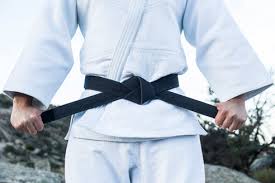Check spelling or type a new query. Man Tying His Black Belt During A Martial Arts Training Stockphoto