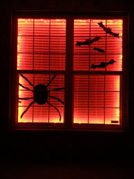 Halloween Window Decor Made By Hanging Orange Lights Between Blinds And Window Black Butcher Paper Cutouts Halloween Window Window Decor Window Coverings