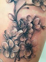 My Cherry Blossom Tattoo In Black And Grey On My Left Thigh Absolutely Love It Blossom Tree Tattoo Blossom Tattoo Cherry Blossom Tattoo