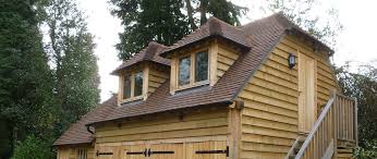 Since the rim joist is on its edge, the builder uses an angled nailing. Crown Oak Buildings