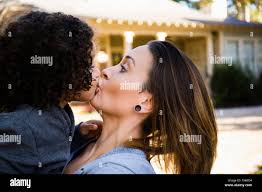 Mother kissing son outdoors Stock Photo - Alamy