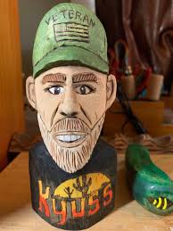 What should I name this carved and painted wood sculpture?