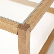 This handmade product also comes with magazine racks and a glass top. Glass And Solid Oak Coffee Table Betsy Maisons Du Monde
