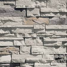 Stone retaining wall, dry stack stone, sculpted undulating stone pattern. Dry Stack