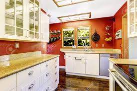 bright red wall and white cabinets