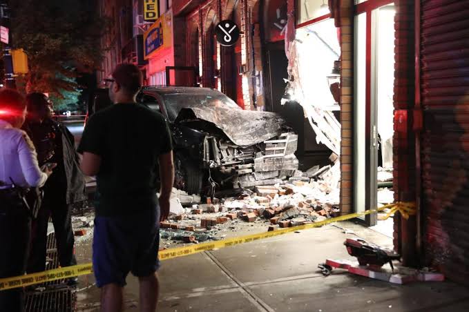 Wild video shows 2 cars almost hit pedestrian as they smash into NYC  building in suspected road rage