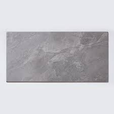 Our pulpis grey stone effect wall and floor tile would go nicely, this is the most similar tile we offer that is suitable for wall use. Noir Stone Effect Light Grey 29 7cm X 59 8cm Wall Floor Tile