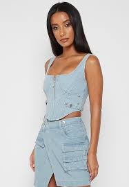 For a casual look, you can wear a bustier top alone with jeans or a skirt, with added studs for a modern, edgy look. Denim Corset Top Light Blue Maniere De Voir