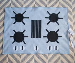 The play kitchen includes a stove, sink, oven, and refrigerator. Felt Stove Diy Kids Play Kitchen Roll It Up Put It Away Merriment Design