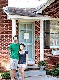 For added elegance, the white siding exterior has given the front door a stately feel. House Crashing Inspired Inexpensive Young House Love Red Brick House Red Brick House Exterior Shutters Brick House