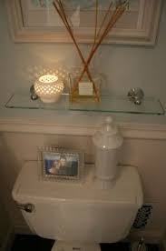 Glass shelves are good for photos and books, and they even add beauty to your bathroom. Behind Toilet Shelves Ideas On Foter Glass Shelves In Bathroom Shelf Above Toilet Bathroom Shelf Decor