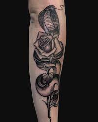 Black And Gray Snake And Rose Tattoo On The Forearm King Cobra Tattoo Cobra Tattoo Snake Tattoo