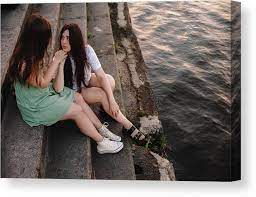 Cute Lesbian Couple Talking While Sitting On Steps By River In City Canvas  Print / Canvas Art by Cavan Images - Pixels Canvas Prints
