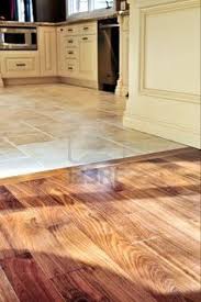 Hardwood And Tile Floor In Residential Home Kitchen And Dining Wood Tile Floor Kitchen Kitchen Floor Tile Dining Room Floor