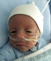 Premature baby born three months early and weighing under 2lb is back at  home before his due date