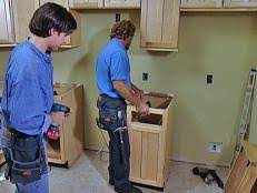 You will definitely need more than one person to make it happen, as simply lifting the cabinets can be tough; Kitchen Catch Up How To Install Cabinets How Tos Diy