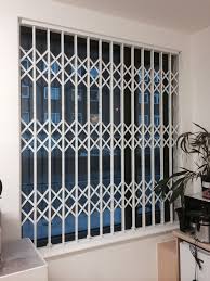 Rsg1000 Retractable Security Grille Securing An Office In Central London Shutter Designs Window Grill Design Folding Doors