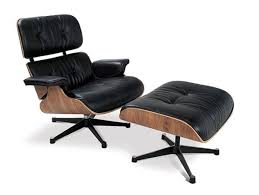 Charles And Ray Eames Debut The Herman Miller Lounge Ottoman Eames Lounge Chair Eames Lounge Modern Lounge Chairs