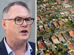 Gold Coast Suns head coach Stuart Dew prepares to pay his respects