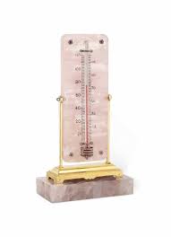These thermometers provide a convenient way to check indoor and outdoor temperatures as well as the current local time. An Early 20th Century Rose Quartz And Gem Set Thermometer By Cartier