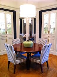 An Octagonal Dining Room Is Accentuated By The Circular Table And Light Fixture While The Horizontal Striped Fabric Black And White Dining Room Interior Decor