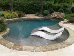 They added the beautiful white ledge loungers and outdoor wrap around couch with fire pit. Freeform Pool With Tanning Ledge Ledge Loungers Rock Waterfall Cocktail Table Swimming Pool New Orleans By The Pool Guy Houzz
