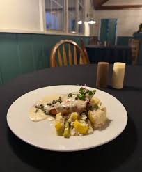Come in and try our Salmon Franchise tonight! Salmon in a creamy lemon  white wine sauce, topped with capers and paired with our vegetable risotto.  Open 4-9 with live music starting at 6!