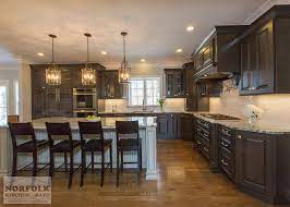 The island is crafted out of solid elegant antique style kitchen units of white finished wooden materials. Greywash Cherry Custom Kitchen With White Island