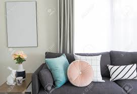 Dark grey sofa what colour cushions; Pink And Blue Cushion On Grey Sofa In Living Room Stock Photo Picture And Royalty Free Image Image 117582686