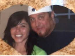 Restored Photo of a Couple The image is a low-resolution, pixelated  photograph of a couple, likely taken in the early