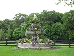 This Summer Our Fountains Are Spilling Thrilling With Lantana Mandevilla Scaveola Vinca Got An Old Fountain Hanging Ar Yard Art Lantana Garden Sculpture
