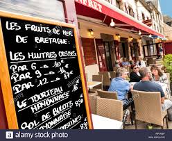 Brittany Seafood Restaurant Blackboard Concarneau Alfresco Les Fruits De Mer Blackboard Menu Including Oysters And Crab Mayonnaise Outside Typical Alfresco French Restaurant With Smiling Diners Outside Ville Close Old Town Concarneau Brittany