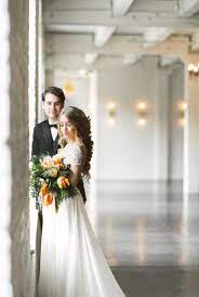 Boho Bride And Groom Pose For Wedding Photos At Modern Wedding Venue With Lots Of Natural Light And Be Wedding Spring Wedding Inspiration Modern Wedding Venue