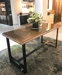 Gather the family around this dining table with iron base that is as earthy as it is elegant wrought iron base is as sturdy as it is beautiful. Antique Patinated Copper Dining Table Andrew Nebbett Designs