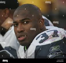 Seattle Seahawks' Shaun Alexander (37) tries to evade Green Bay Packers'  Brady Poppinga during the second quarter of a football game in Seattle,  Monday, Nov. 27, 2006. (AP Photo/John Froschauer Stock Photo