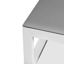 Made of cast aluminum, the table is coated with a brilliant white powdercoat finish to brighten patios and balconies with modern geometry. White Elara Aluminium Outdoor Coffee Table Temple Webster
